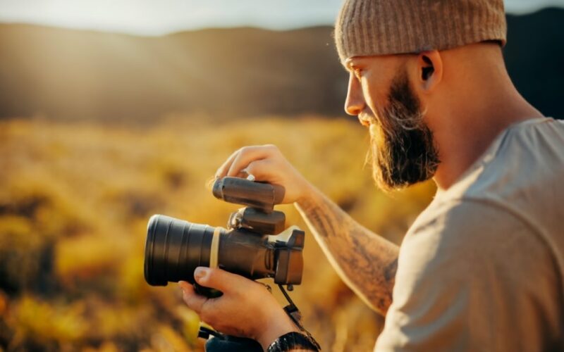 Man shooting video at the golden hour on DSLR